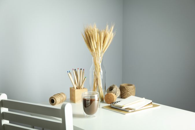 Work table with yarn, notebooks, pencils and chair