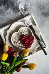 St. Valentine's Day card with plates, crystal, heart ornaments and tulips