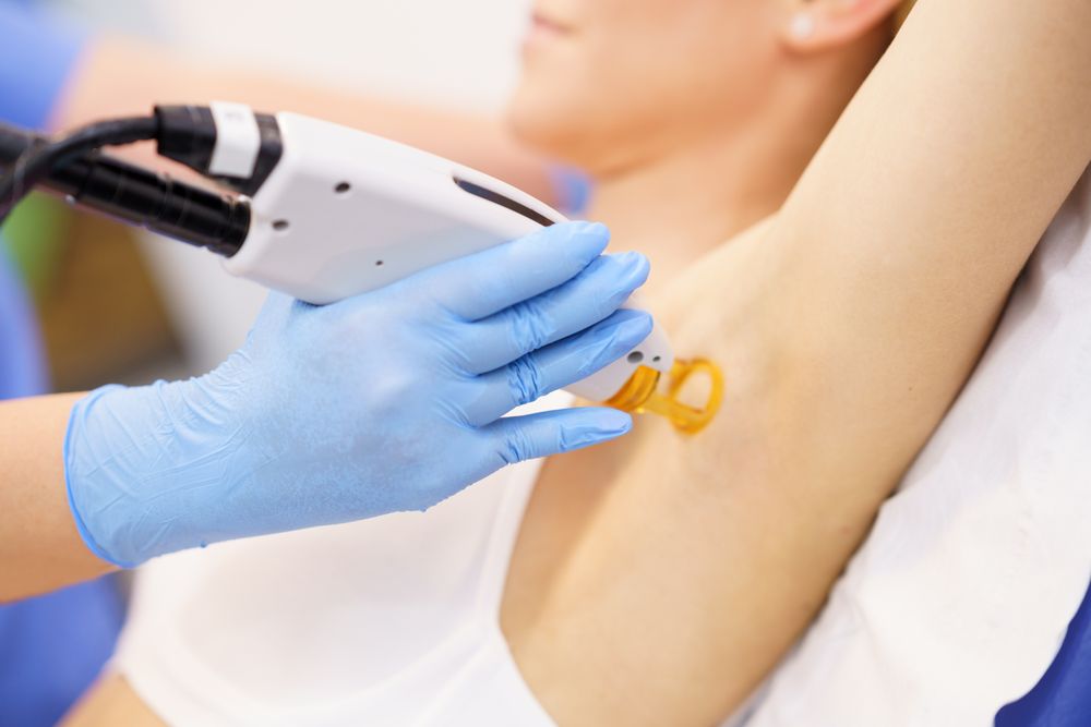 Female receiving underarm laser hair removal at a beauty center