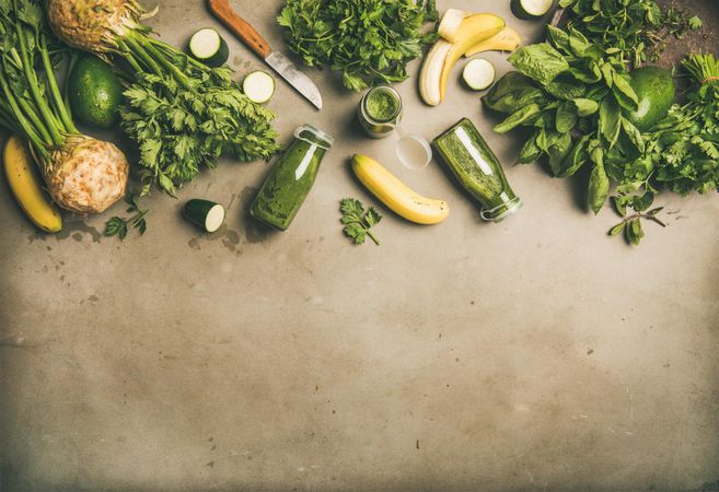 Smoothie ingredients with avocado banana, zucchini, on grey table, with copy space