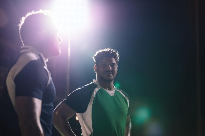 Rugby players on field under lights