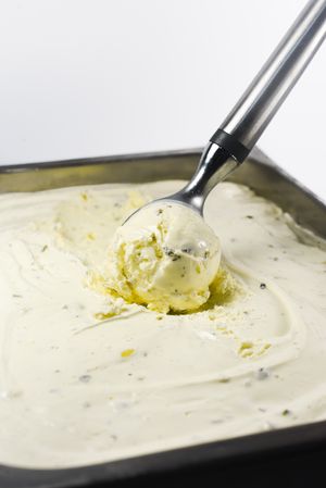 Scooping out a ball of pistachio ice cream