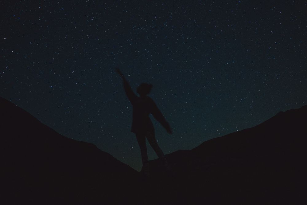 Silhouette of a person on a starry night