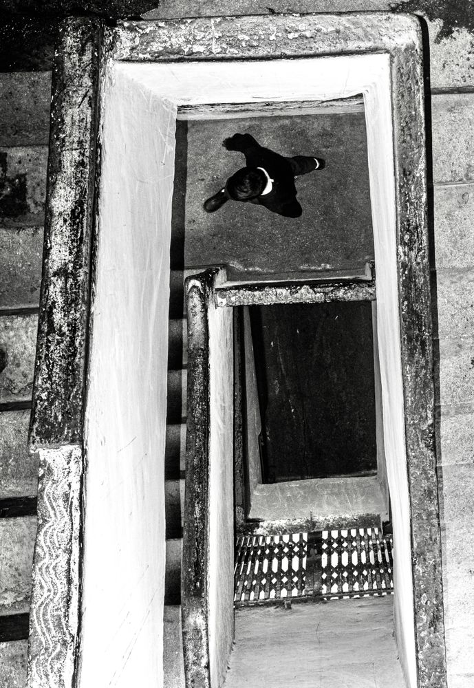 Top view of a boy on staircase in grayscale