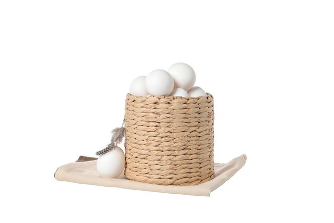 eggs in a round basket, isolated on blank background.
