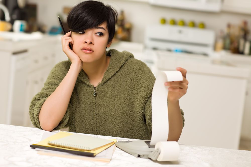 Young Woman Agonizing Over Financial Calculations