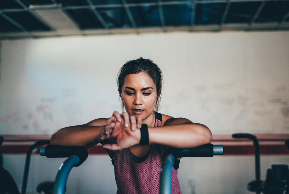 Woman checking watch in the gym