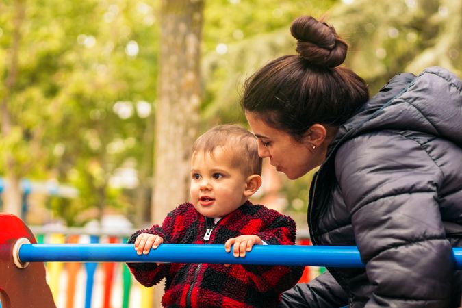 mother and baby playing in a playground
