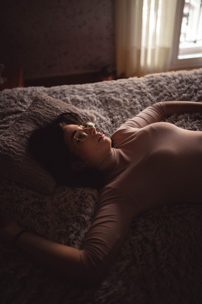 Young woman lying on bed