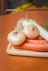 Fresh vegetables on cutting board in the kitchen