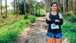 Female trail athlete posing with race number