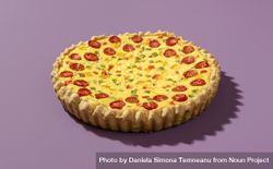 Homemade quiche isolated on a purple background 0PwRlb