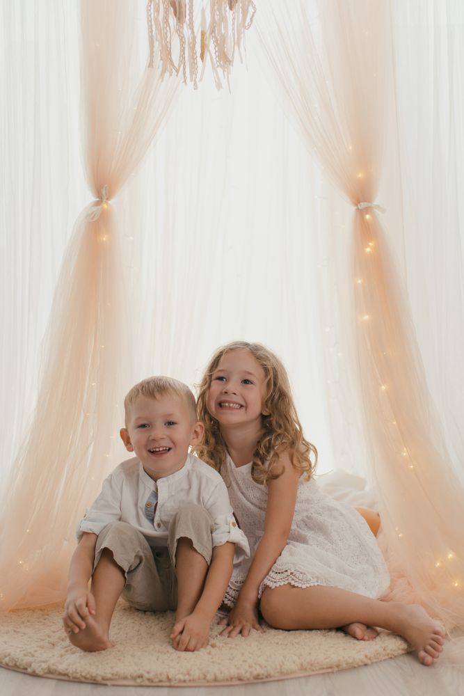 Sister embracing little brother at home