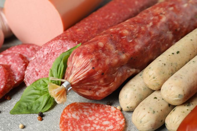 Cured sausages on grey table