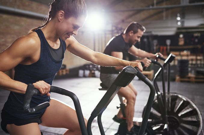 Fit couple taking exercise class together at indoor gym