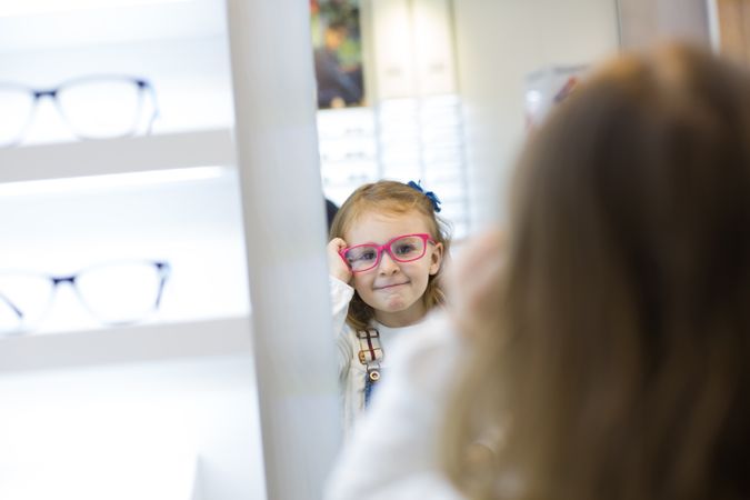 Young girl trying on glasses