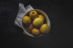 Fresh lemons on dark background.
