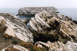 Rocky formations in the island of Baleal on the Atlantic coast in a foggy day. Peniche, Portugal