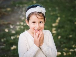 Portrait of charming smiling little girl in park