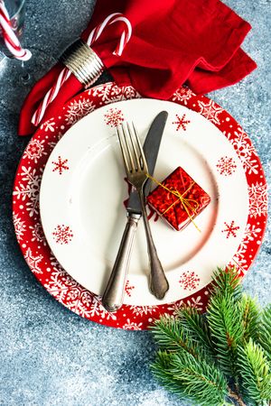 Christmas dinner concept with seasonal red plate and decorative plate