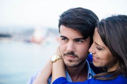 Loving couple embracing on urban pier with dock