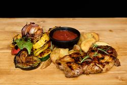 Fried meat and vegetables near ketchup