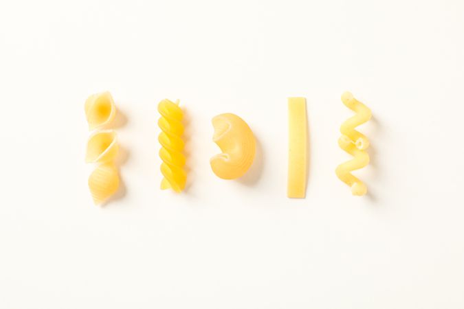 Flat lay composition with pasta on bright background, space for text