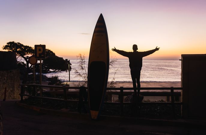 Man practicing paddle surfing with neoprene in a sunrise