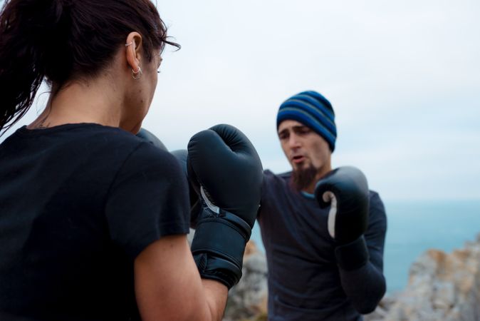 Boxers exercising on cliff