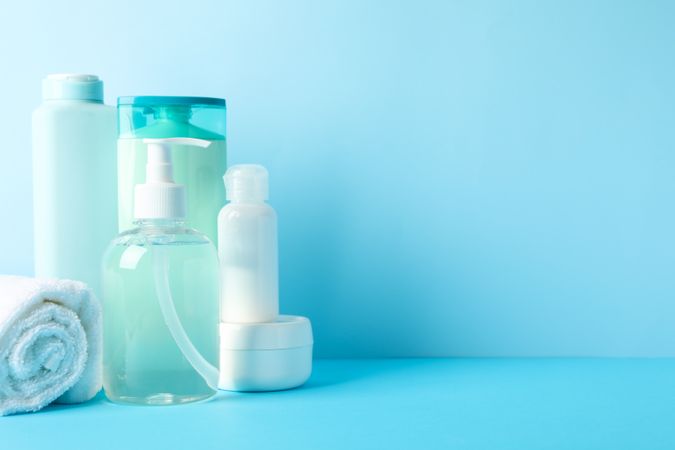 Body care products on blue background. Personal hygiene