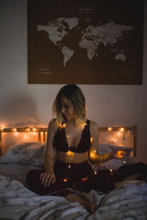 Woman surrounded with light garland