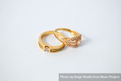 Two diamond gold rings on plain table with copy space 0V6a9j