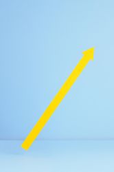 Yellow arrow pointing up over blue background