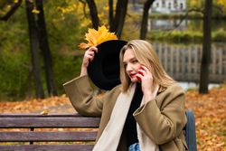 Woman on park bench in autumn