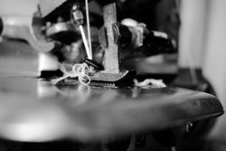 Close up of tangled string through sewing machine needle