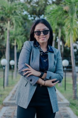 Assured confidence: Elegant woman in stylish outdoor setting