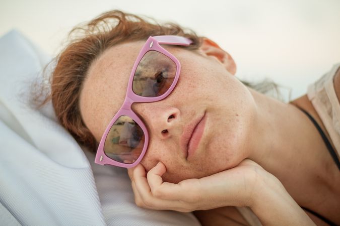 Woman in sunglasses resting on resort