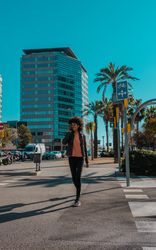 Woman with afro hair walking through the streets