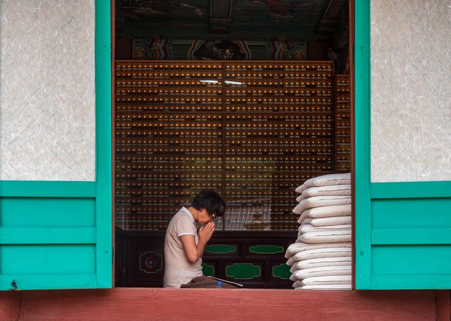 Busan, South Korea - August, 05 2017: Asian woman praying at home