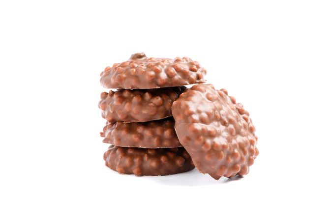Stack of chocolate cookies with caramel filling isolated on plain background
