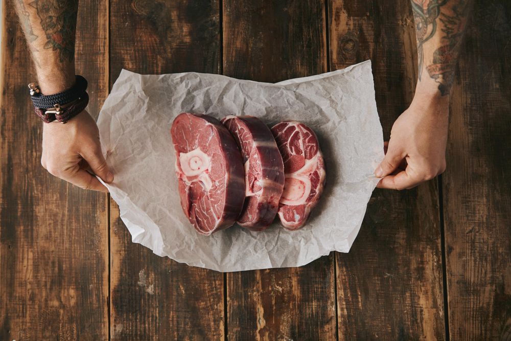 Man with three steaks