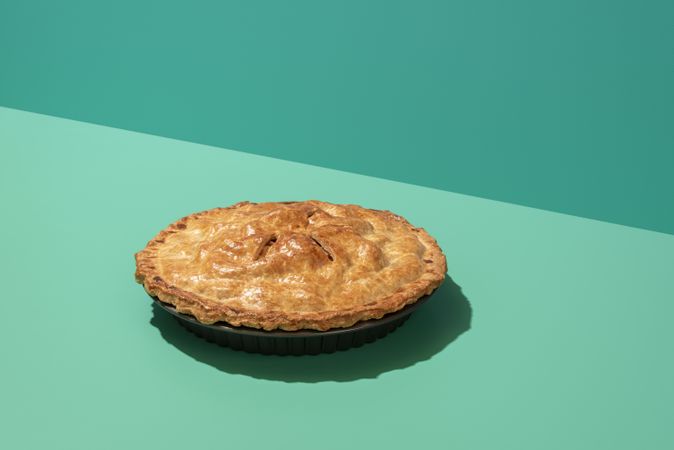 Apple pie minimalist on a green table in bright light