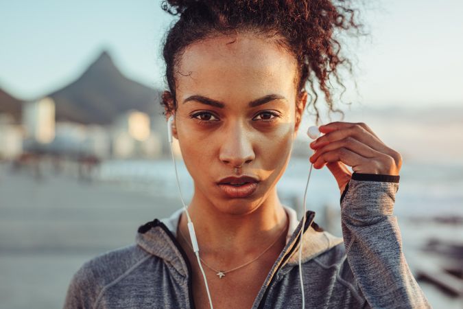 Close up of woman athlete wearing earphones outdoors