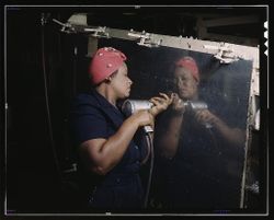 Nashville, TN, USA - 1940s: Female operating a hand drill at Vultee-Nashville