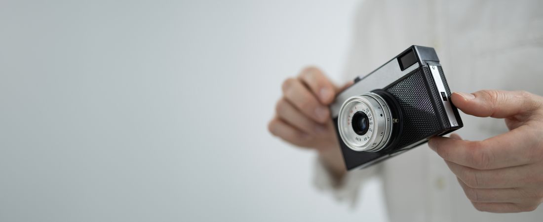 Young man holding retro camera