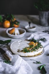 Tangerine cake decorated with whipped cream and sliced citrus