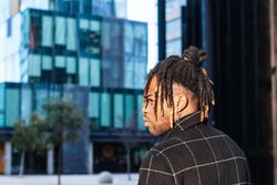 Informal Black man with dreadlocks in hairstyle