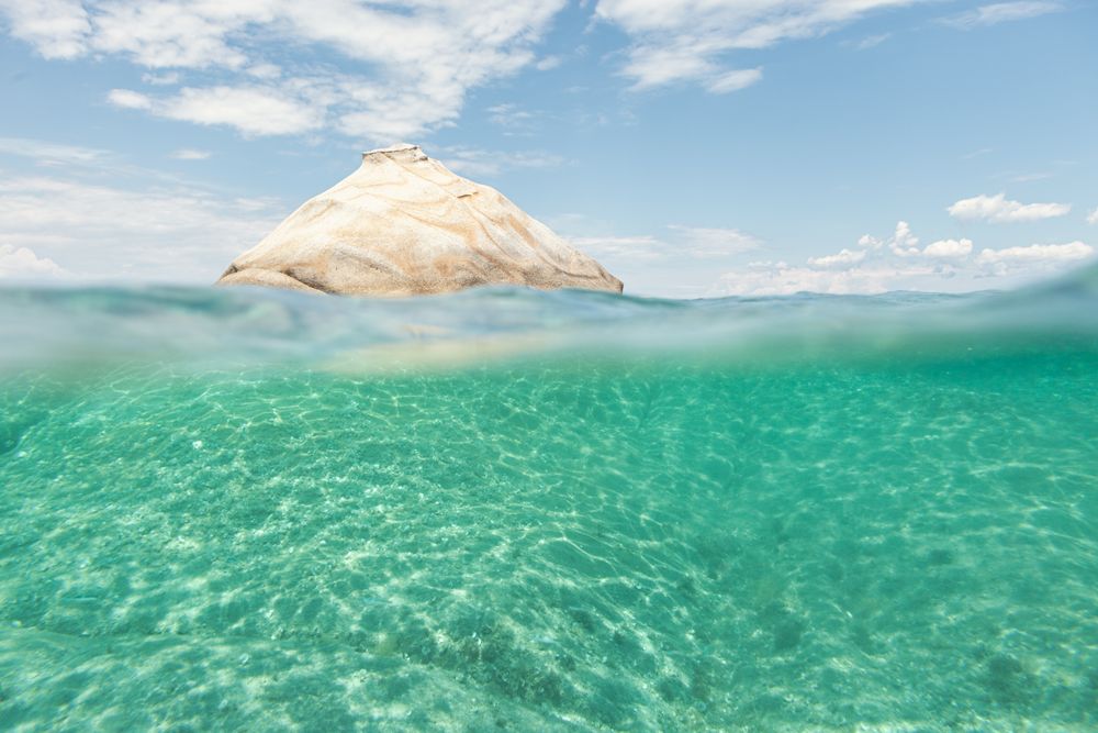 Rocky hill in crystal water