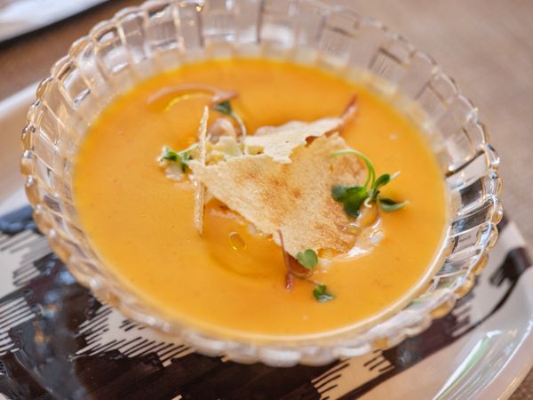 Tasty soup in glass plate