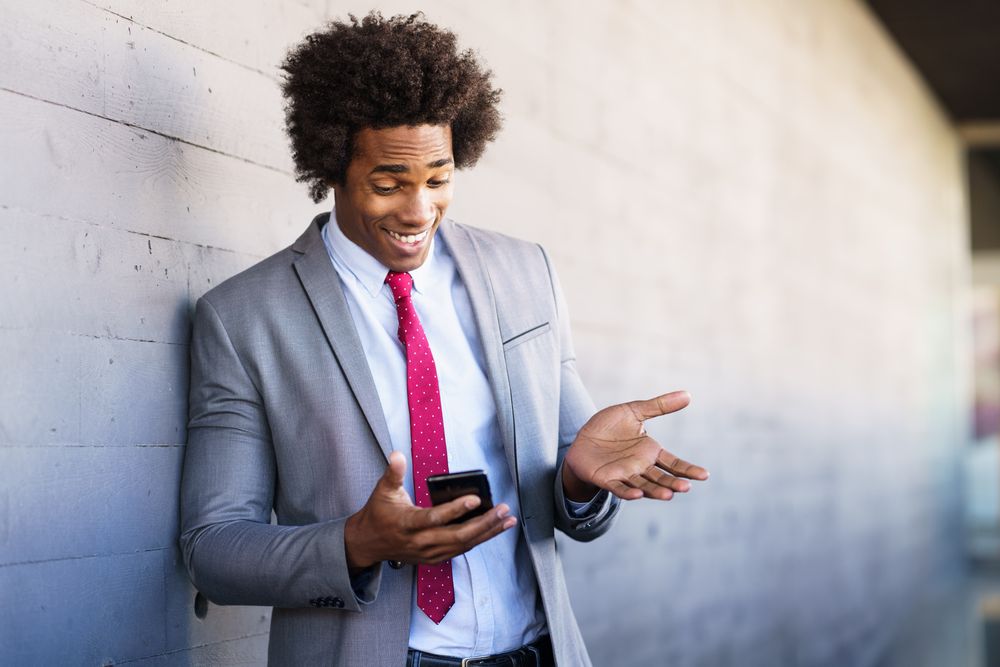 Smiling man having video call on his smart phone